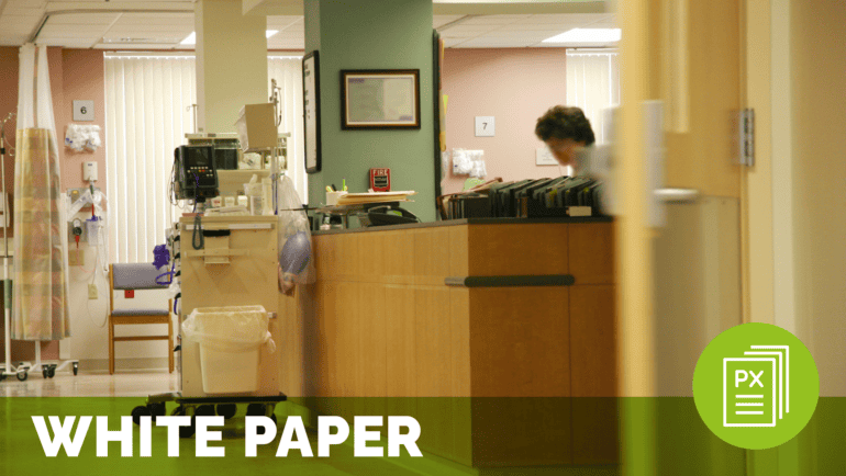 a person standing behind a counter in a quiet hospital corridor