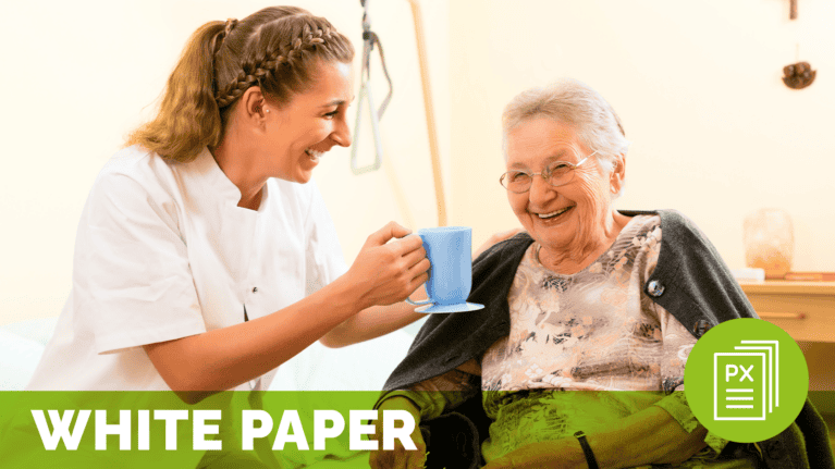 a woman holding a blue mug with a smiling woman in a wheelchair in long-term care