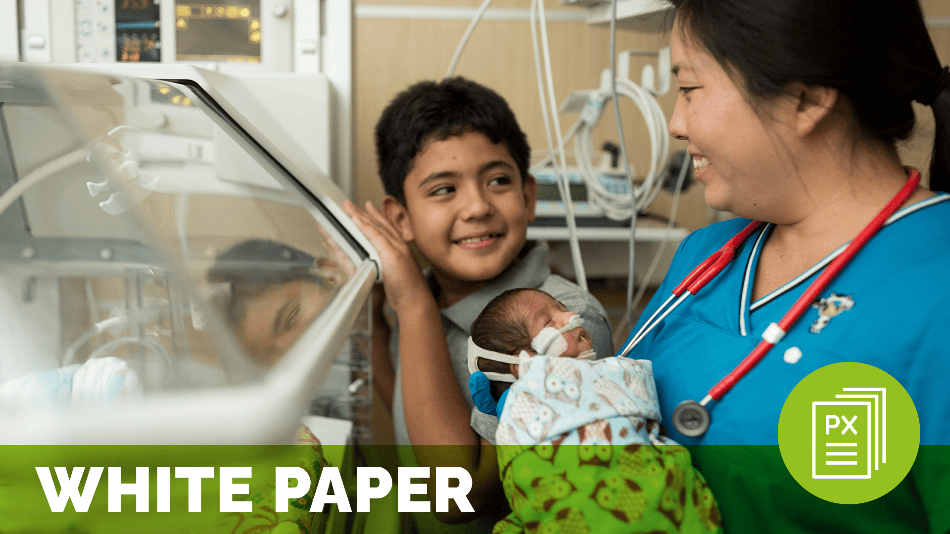 a female healthcare worker holding a baby with a smiling child by an incubator