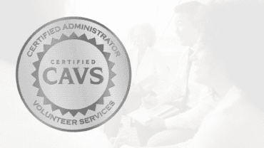 a badge emblazoned with "Certified Administrator of Volunteer Services (CAVS) is overlaid atop an image of business people gathered in a meeting