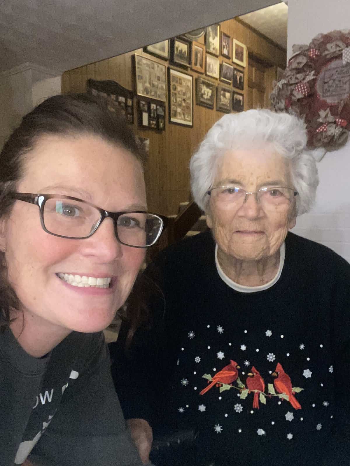 two women in glasses smile for a selfie