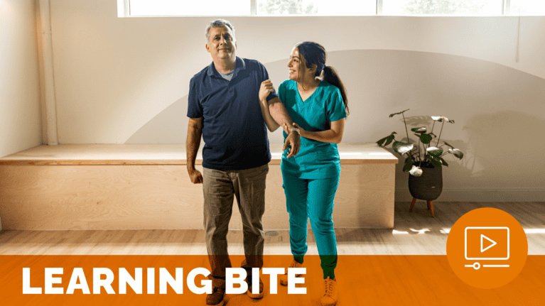 a man and physical therapist standing in a room