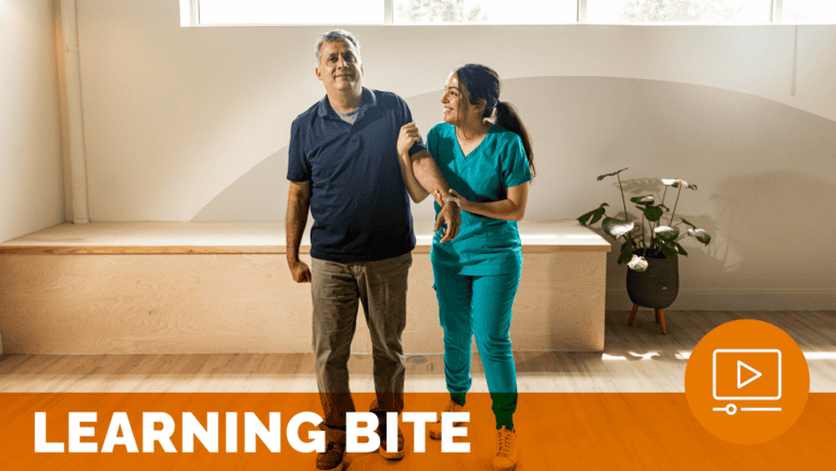 a man and physical therapist standing in a room