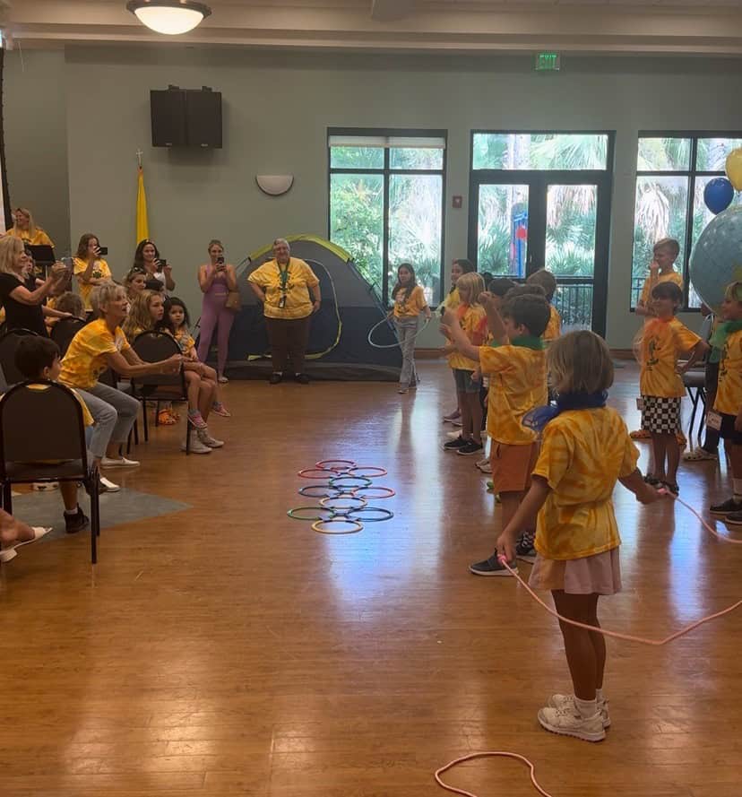 an image of a group of children at a summer camp, performing a skit