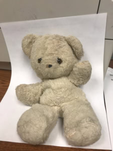 a stuffed bear on a paper